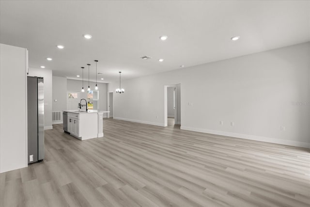 1970 SW 160th Pl, Ocala, FL 34473 - unfurnished living room with recessed lighting, light wood finished floors, and a chandelier