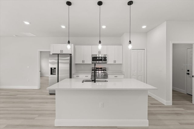 1970 SW 160th Pl, Ocala, FL 34473 - kitchen featuring stainless steel appliances, light wood-style flooring, white cabinets, light countertops, and recessed lighting