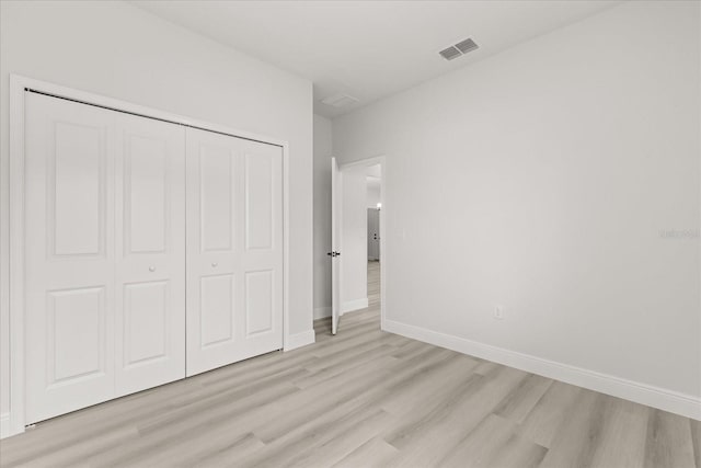 1970 SW 160th Pl, Ocala, FL 34473 - unfurnished bedroom featuring light wood-style floors and a closet