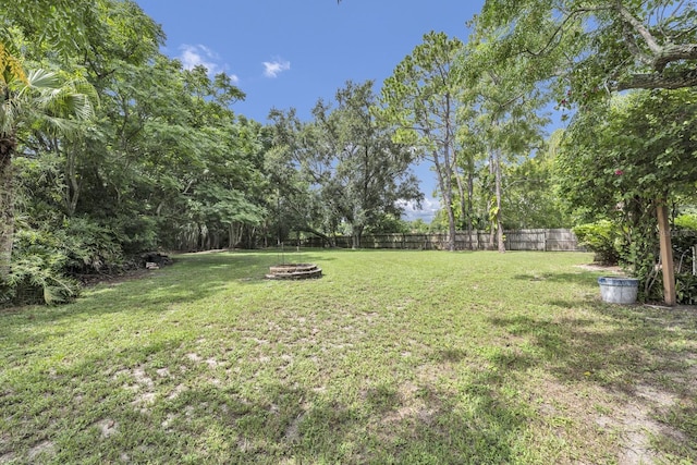 9001 New Orleans Ct, Orlando, FL 32818 - fenced backyard featuring a fire pit