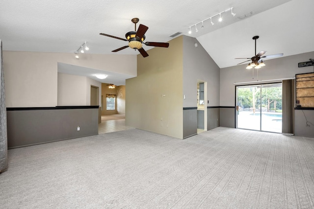9001 New Orleans Ct, Orlando, FL 32818 - unfurnished living room with rail lighting, a ceiling fan, carpet, high vaulted ceiling, and a textured ceiling
