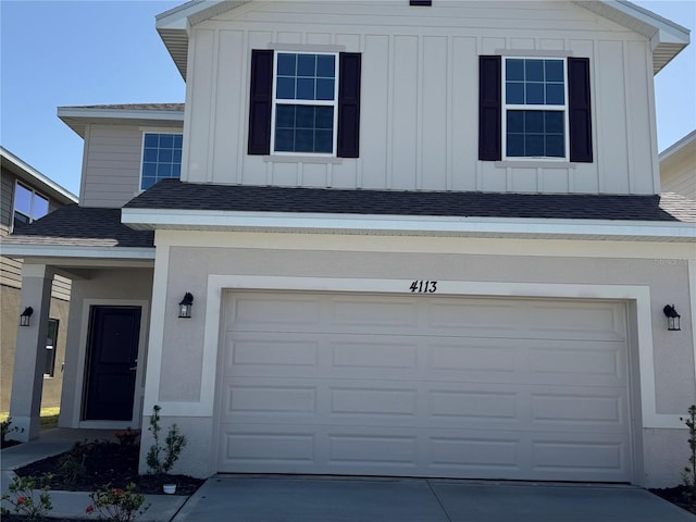 4113 Sagefield Dr, Harmony, FL 34773 - view of front of home featuring board and batten siding, an attached garage, roof with shingles, and concrete driveway