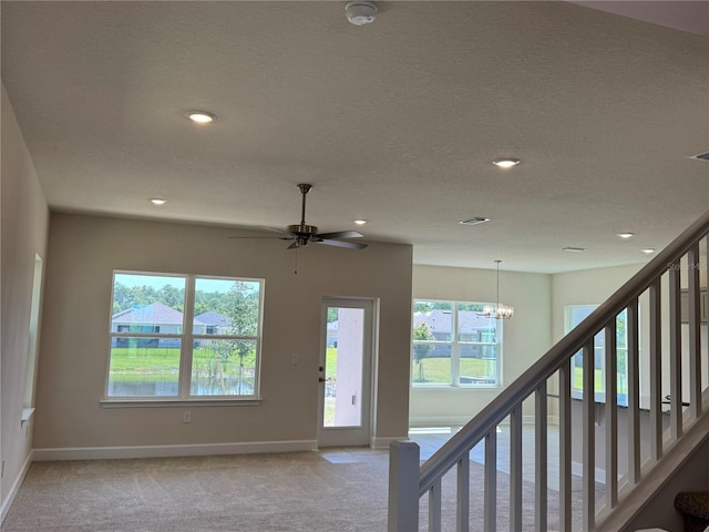 4113 Sagefield Dr, Harmony, FL 34773 - entrance foyer featuring light colored carpet, plenty of natural light, a chandelier, recessed lighting, and stairs