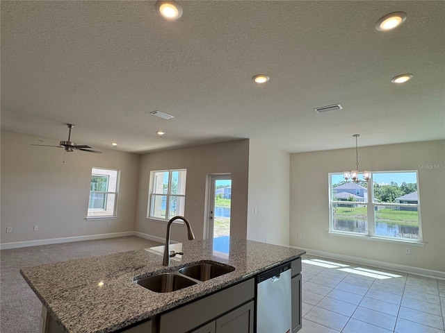 4113 Sagefield Dr, Harmony, FL 34773 - kitchen featuring dishwasher, open floor plan, a chandelier, light stone counters, and an island with sink