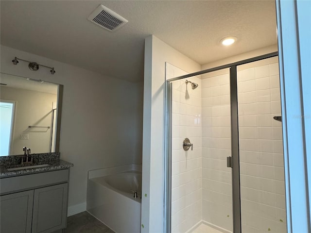 4113 Sagefield Dr, Harmony, FL 34773 - full bath with a bath, a shower stall, vanity, and a textured ceiling