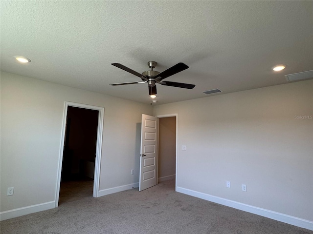 4113 Sagefield Dr, Harmony, FL 34773 - unfurnished bedroom featuring light carpet, recessed lighting, a walk in closet, ceiling fan, and a textured ceiling