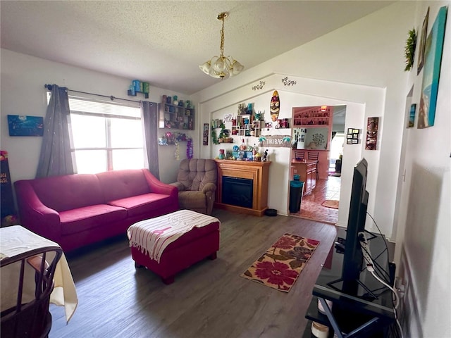 603 Reston Pl, Davenport, FL 33897 - living room featuring wood finished floors, a chandelier, a fireplace, and a textured ceiling