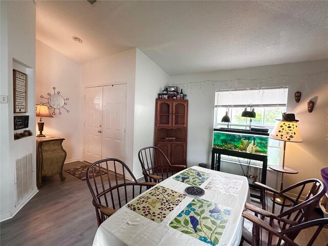 603 Reston Pl, Davenport, FL 33897 - dining room with wood finished floors, a textured ceiling, and vaulted ceiling