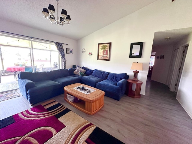 603 Reston Pl, Davenport, FL 33897 - living room featuring lofted ceiling, wood finished floors, and a chandelier