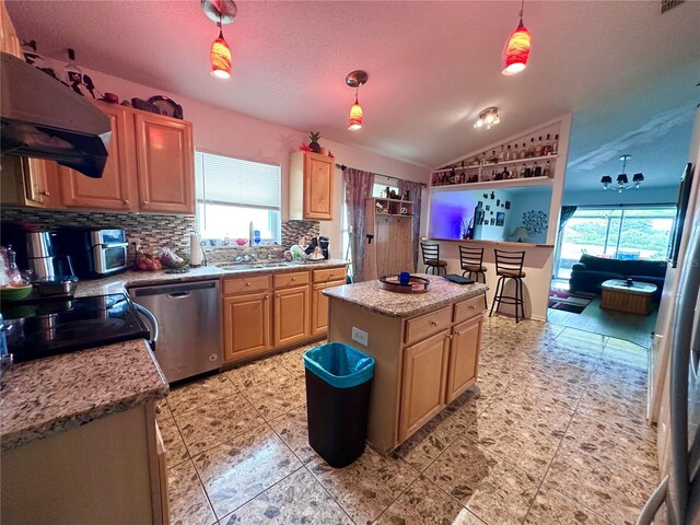 603 Reston Pl, Davenport, FL 33897 - kitchen with stainless steel dishwasher, extractor fan, plenty of natural light, decorative backsplash, and vaulted ceiling