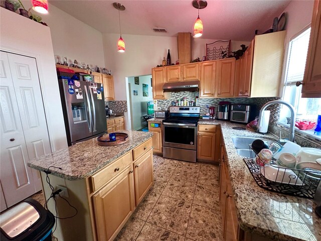 603 Reston Pl, Davenport, FL 33897 - kitchen featuring appliances with stainless steel finishes, under cabinet range hood, decorative backsplash, light stone countertops, and pendant lighting