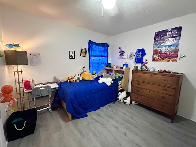 603 Reston Pl, Davenport, FL 33897 - bedroom with wood finished floors, a textured ceiling, and ceiling fan