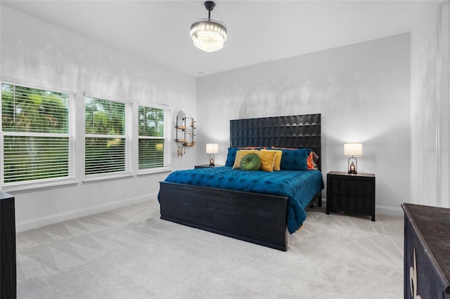 2149 Raglan Cir, Ormond Beach, FL 32174 - carpeted bedroom with a chandelier and baseboards
