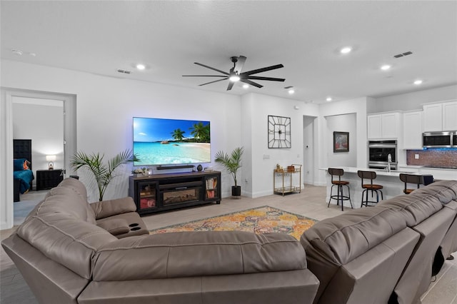 2149 Raglan Cir, Ormond Beach, FL 32174 - living area featuring ceiling fan, recessed lighting, light wood-style flooring, and a glass covered fireplace