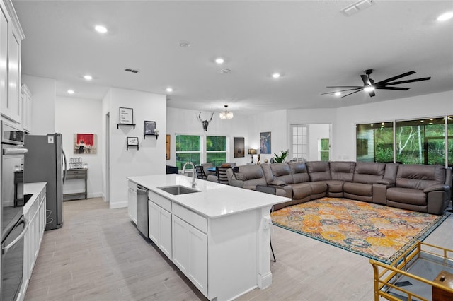 2149 Raglan Cir, Ormond Beach, FL 32174 - kitchen featuring a kitchen island with sink, ceiling fan, white cabinetry, light wood-type flooring, and recessed lighting