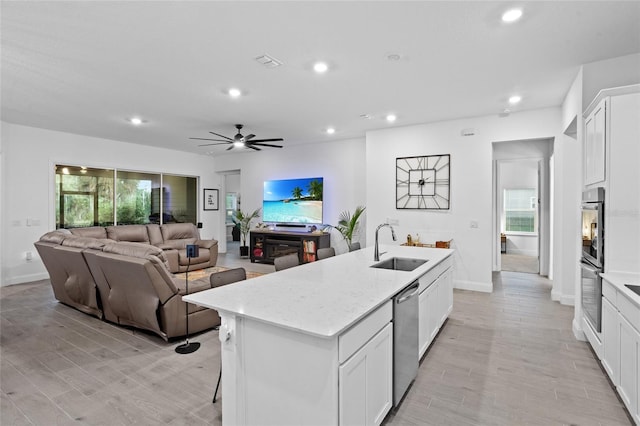 2149 Raglan Cir, Ormond Beach, FL 32174 - kitchen featuring recessed lighting, open floor plan, dishwasher, white cabinets, and a center island with sink