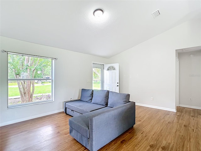 14939 SW 46th Cir, Ocala, FL 34473 - living area with healthy amount of natural light, wood finished floors, and vaulted ceiling