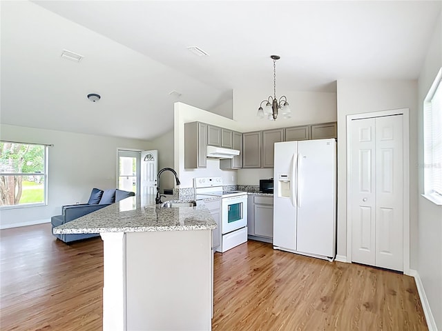 14939 SW 46th Cir, Ocala, FL 34473 - kitchen with white appliances, gray cabinetry, under cabinet range hood, vaulted ceiling, and a chandelier