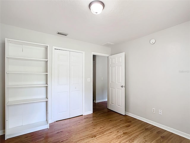 14939 SW 46th Cir, Ocala, FL 34473 - unfurnished bedroom featuring wood finished floors and a closet