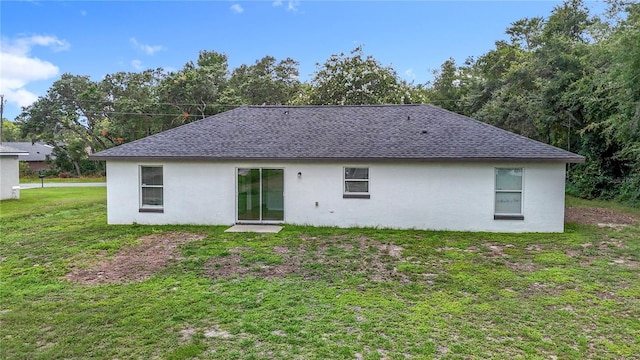 14939 SW 46th Cir, Ocala, FL 34473 - back of house with stucco siding, a shingled roof, and a yard