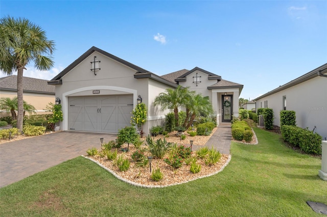 2338 Clemblue Rd, Clermont, FL 34715 - view of front facade featuring decorative driveway, stucco siding, a front yard, an attached garage, and roof with shingles