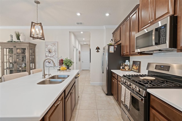 2338 Clemblue Rd, Clermont, FL 34715 - kitchen with stainless steel appliances, ornamental molding, light countertops, hanging light fixtures, and a chandelier