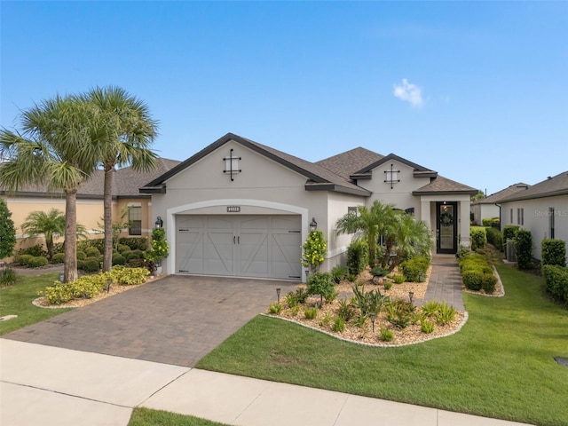 2338 Clemblue Rd, Clermont, FL 34715 - view of front facade featuring stucco siding, an attached garage, a front lawn, driveway, and roof with shingles