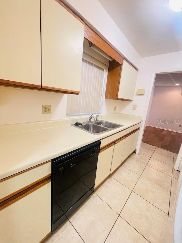 1980 Williams Manor Ave, Orlando, FL 32811 - kitchen with black dishwasher, light countertops, and light tile patterned floors