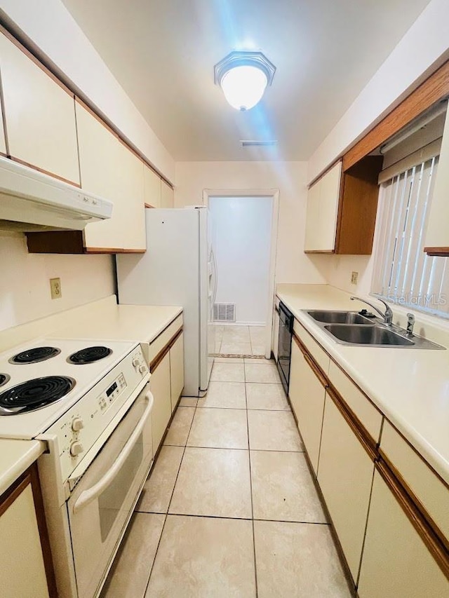 1980 Williams Manor Ave, Orlando, FL 32811 - kitchen with white appliances, under cabinet range hood, light countertops, and light tile patterned floors