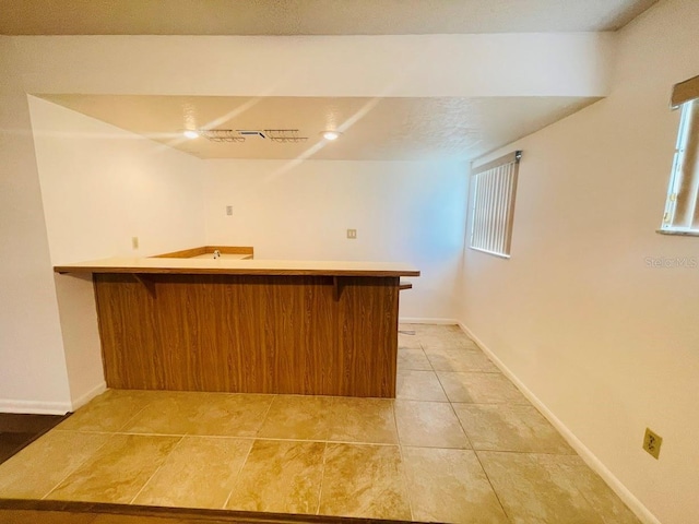 1980 Williams Manor Ave, Orlando, FL 32811 - indoor wet bar with light tile patterned flooring and baseboards