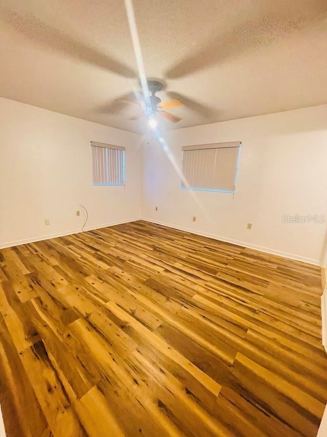 1980 Williams Manor Ave, Orlando, FL 32811 - empty room featuring a ceiling fan, a textured ceiling, and hardwood / wood-style floors