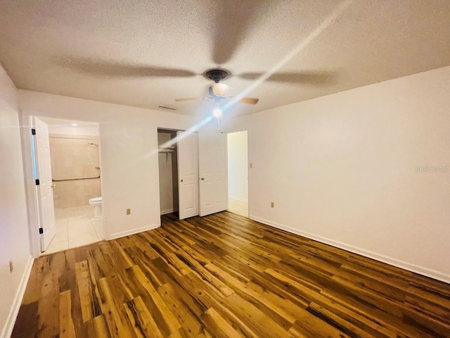 1980 Williams Manor Ave, Orlando, FL 32811 - unfurnished bedroom featuring wood finished floors, a textured ceiling, ensuite bathroom, a closet, and ceiling fan