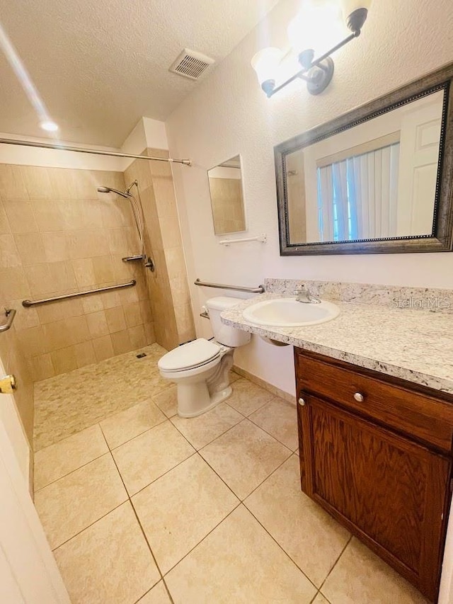 1980 Williams Manor Ave, Orlando, FL 32811 - full bathroom featuring a tile shower, a textured ceiling, tile patterned flooring, and vanity