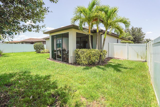 2647 Running Oak Ct, North Port, FL 34289 - rear view of property with stucco siding, a sunroom, and a fenced backyard