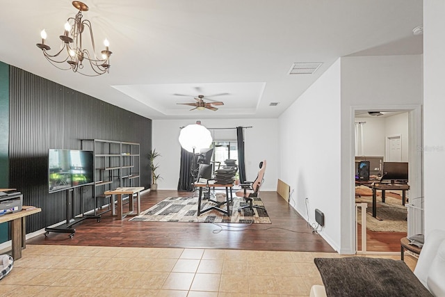 2647 Running Oak Ct, North Port, FL 34289 - dining room featuring an office area, tile patterned flooring, a raised ceiling, an accent wall, and a chandelier