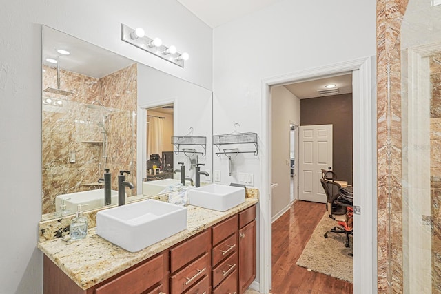 2647 Running Oak Ct, North Port, FL 34289 - bathroom featuring double vanity, wood finished floors, and a tile shower