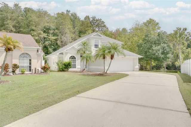 2262 Stonehedge Loop, Kissimmee, FL 34743 - view of front of house with concrete driveway, a front yard, a garage, and stucco siding