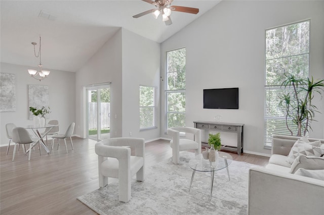 2262 Stonehedge Loop, Kissimmee, FL 34743 - living room featuring high vaulted ceiling, wood finished floors, a chandelier, and ceiling fan