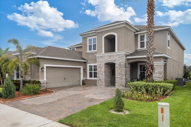 15264 Shonan Gold Dr, Winter Garden, FL 34787 - view of front of property featuring stucco siding, stone siding, decorative driveway, an attached garage, and a front lawn