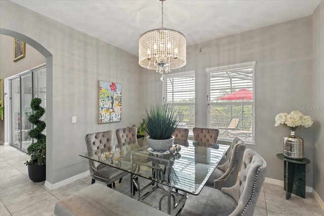 15264 Shonan Gold Dr, Winter Garden, FL 34787 - dining room featuring arched walkways, a chandelier, and light tile patterned floors