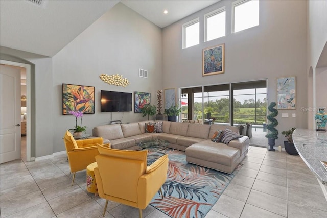 15264 Shonan Gold Dr, Winter Garden, FL 34787 - living room with high vaulted ceiling, light tile patterned floors, and arched walkways