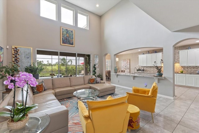 15264 Shonan Gold Dr, Winter Garden, FL 34787 - living area with arched walkways, high vaulted ceiling, light tile patterned floors, and recessed lighting