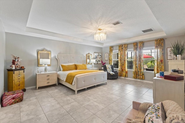 15264 Shonan Gold Dr, Winter Garden, FL 34787 - bedroom with a tray ceiling, light tile patterned floors, a textured ceiling, and a chandelier