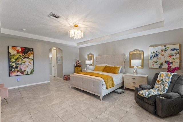 15264 Shonan Gold Dr, Winter Garden, FL 34787 - bedroom featuring a raised ceiling, arched walkways, light tile patterned flooring, and a chandelier