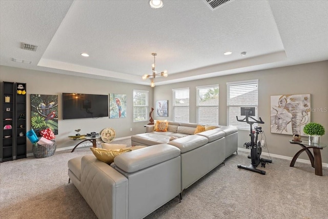 15264 Shonan Gold Dr, Winter Garden, FL 34787 - living area featuring a tray ceiling, light carpet, a textured ceiling, a chandelier, and recessed lighting