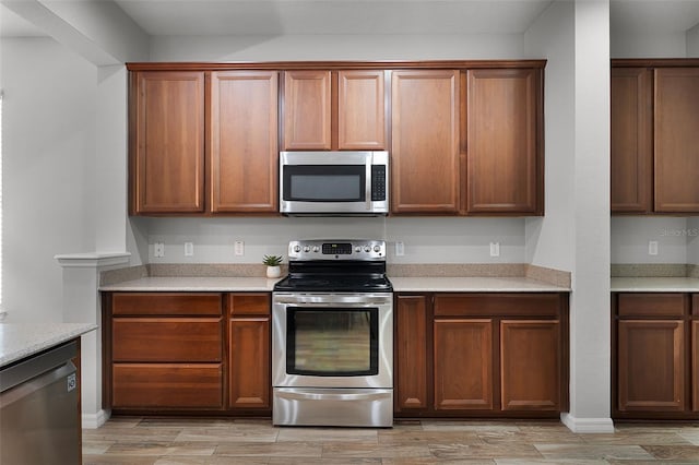 6539 Chagford Ln, Windermere, FL 34786 - kitchen with stainless steel appliances, light countertops, and light wood-type flooring