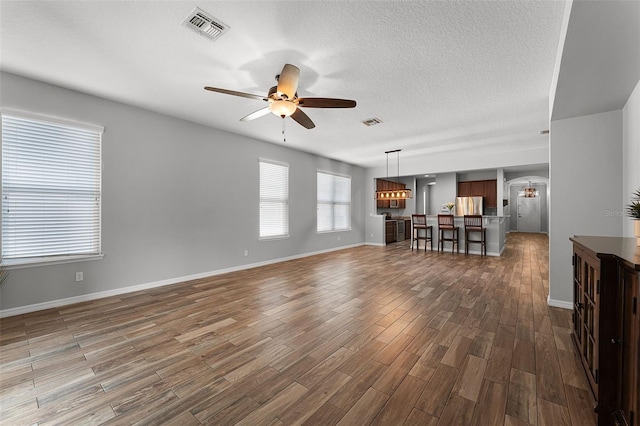 6539 Chagford Ln, Windermere, FL 34786 - living area featuring ceiling fan, wood finished floors, and a textured ceiling