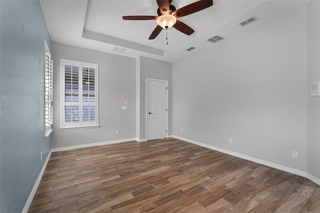 6539 Chagford Ln, Windermere, FL 34786 - empty room with a tray ceiling, ceiling fan, and wood finished floors
