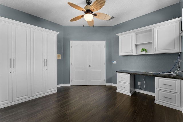 6539 Chagford Ln, Windermere, FL 34786 - unfurnished office with a ceiling fan, dark wood-type flooring, built in study area, and a textured ceiling