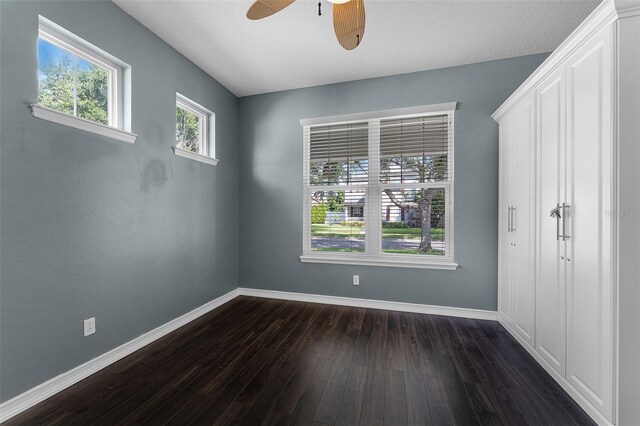 6539 Chagford Ln, Windermere, FL 34786 - unfurnished bedroom with dark wood-style floors and a ceiling fan